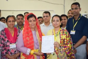 Himachal Pradesh Chief Minister Sukhvinder Singh Sukhu's wife and Congress candidate Kamlesh Thakur receives his victory certificate after winning Dehra assembly by-poll elections, in Kangra district, Saturday, July 13, 2024.(IANS)