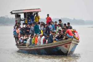 Kamrup : People travel on a boat to reach Chaygaon to cast their vote ahead of the third phase of Lok Sabha elections in Kamrup on Monday, May 06, 2024. (Photo: IANS)