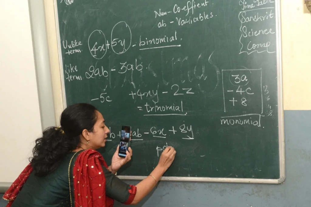 Mumbai: A teacher working at a government school takes online class inside an empty class room in Mumbai on Tuesday January 04, 2022. Amid a surge in COVID-19 cases in Mumbai, including the Omicron variant, the civic body on Monday decided to shut schools of all mediums for classes 1 to 9 and 11 till January 31 (Photo:IANS)