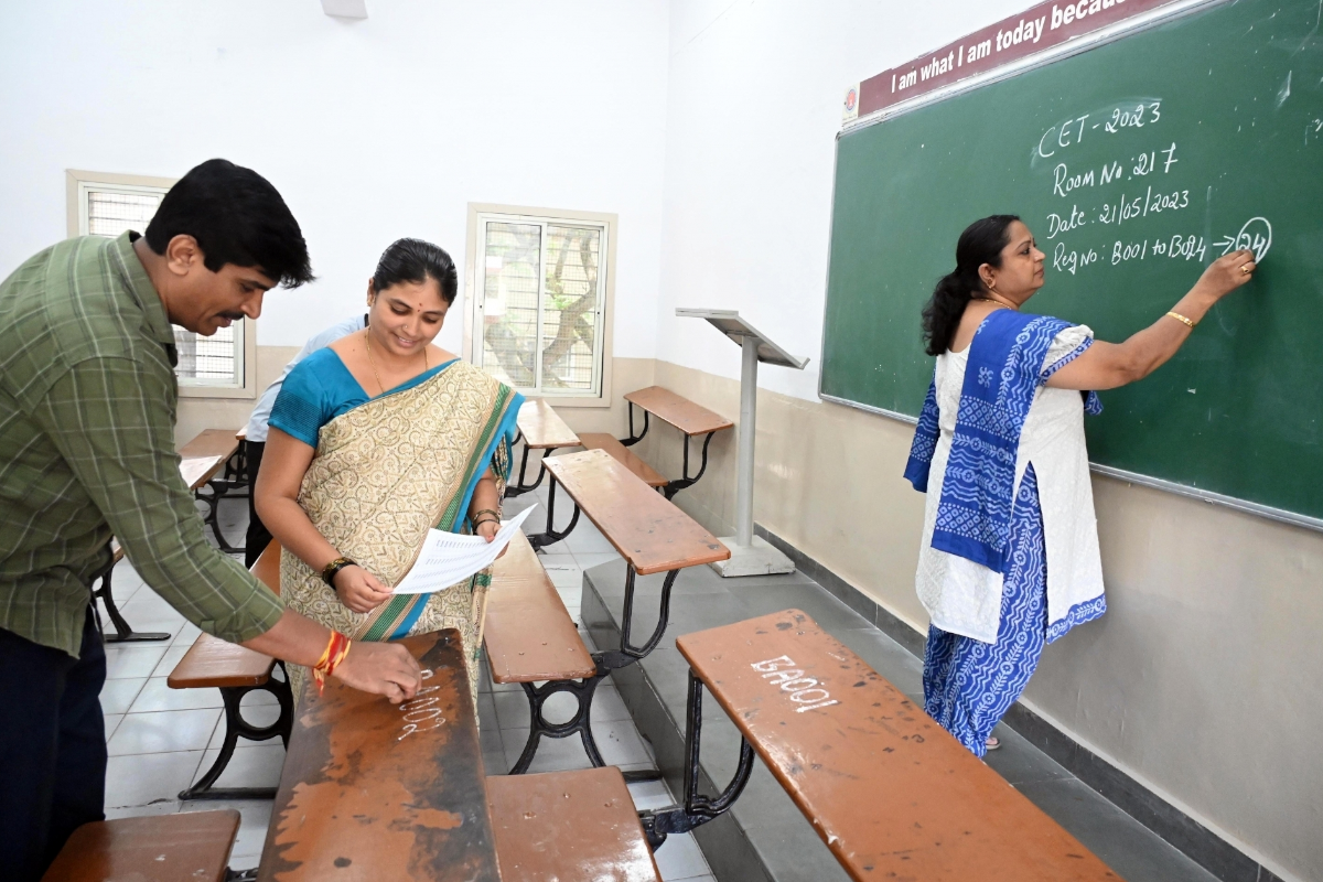 Bengaluru: College teachers and staff assign roll numbers on the desk ahead of CET examination at Sheshadri collage, in Bengaluru on Friday, May 19, 2023. (Photo: Dhananjay Yadav/IANS)